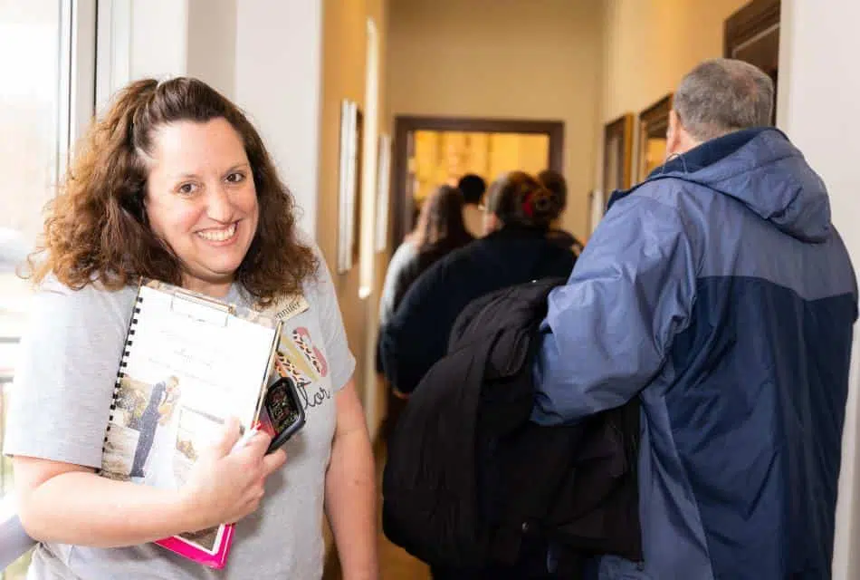 Woman smiling and holding wedding planning materials