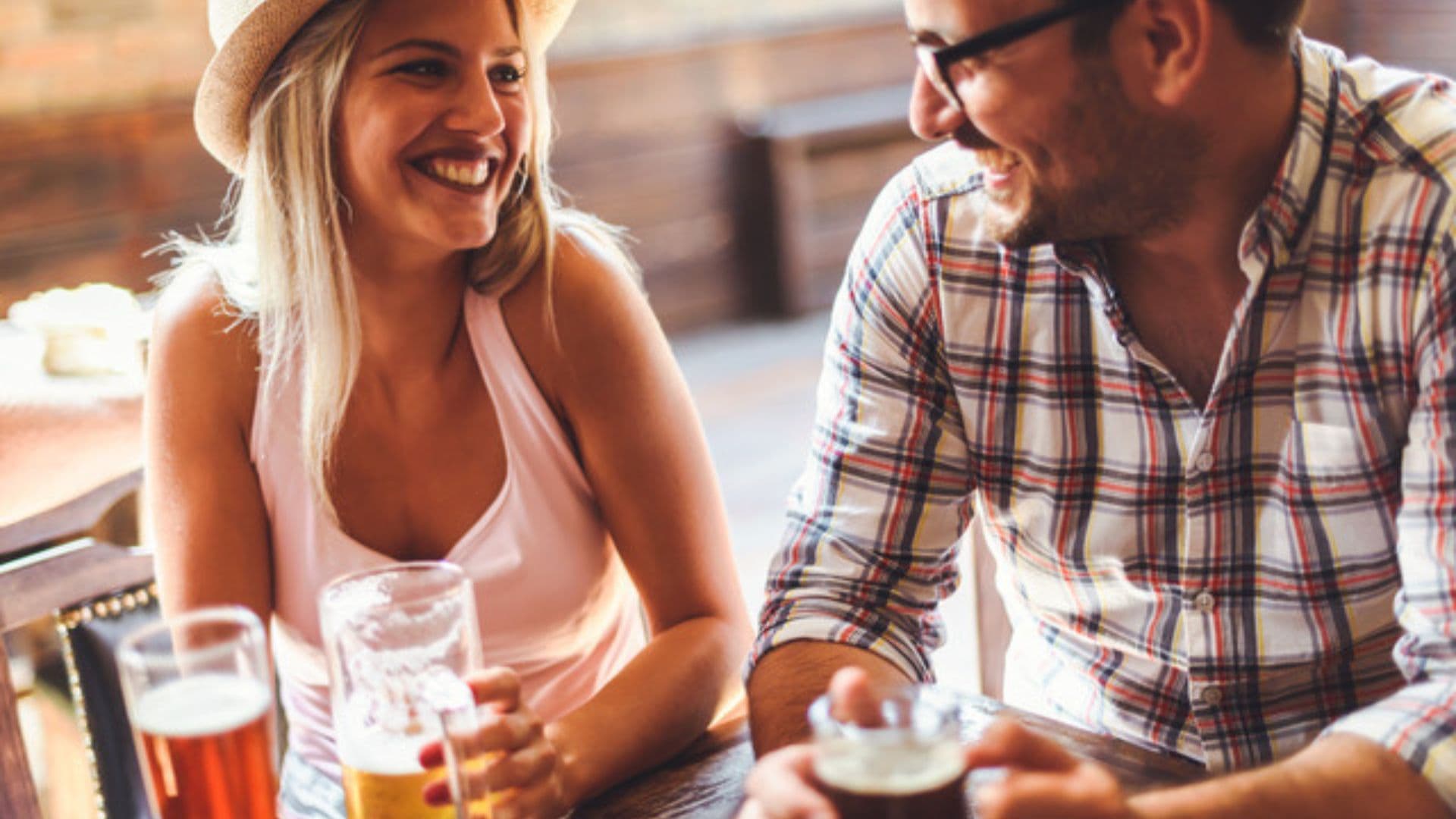 A couple laughing and drinking beer on Oktoberfest